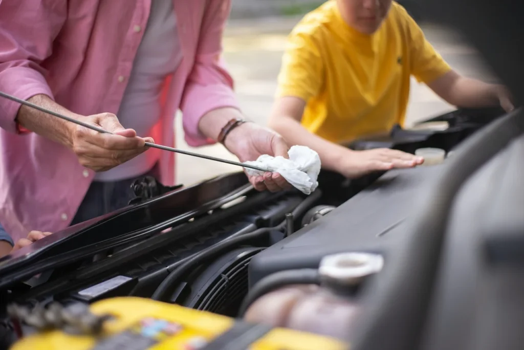 Checking oil dipstick level as a way for how to tell if your engine is burning oil