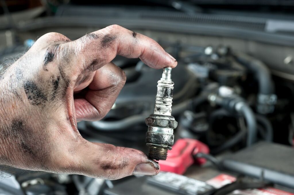 Spark plugs with visible corrosion, a clear indicator of how to tell if spark plugs need replacing.