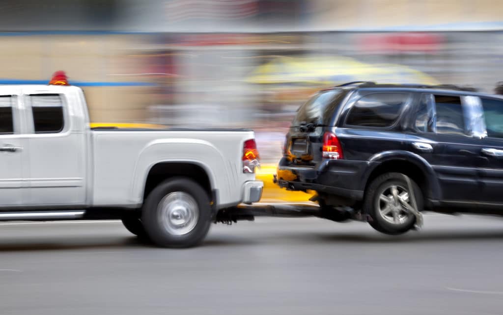 Driving carefully while learning how to tow a car safely on a road.