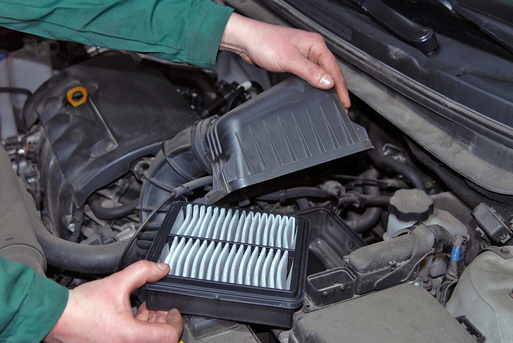 How to replace your car's air filter - Removing the old air filter from the housing.