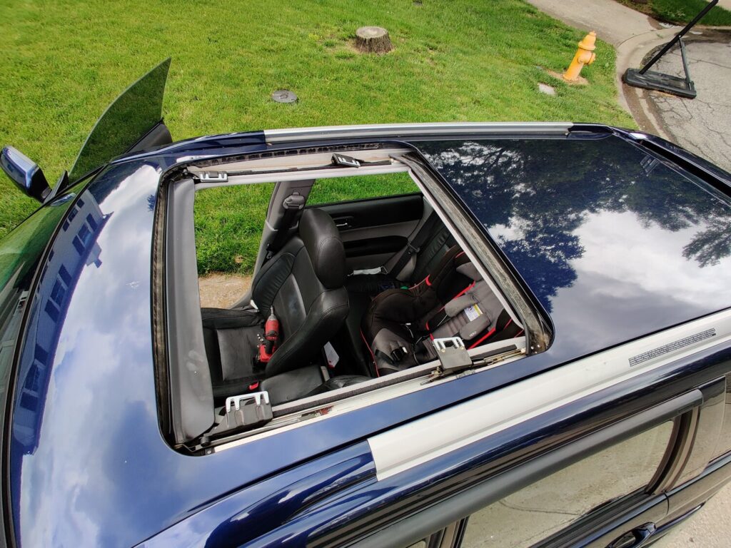 Cleaning the track to fix a stuck sunroof on a car