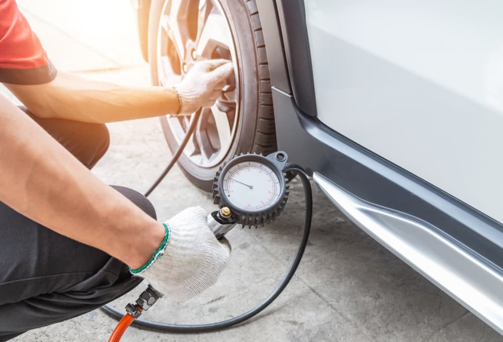 Using a digital tire pressure gauge to check tire pressure